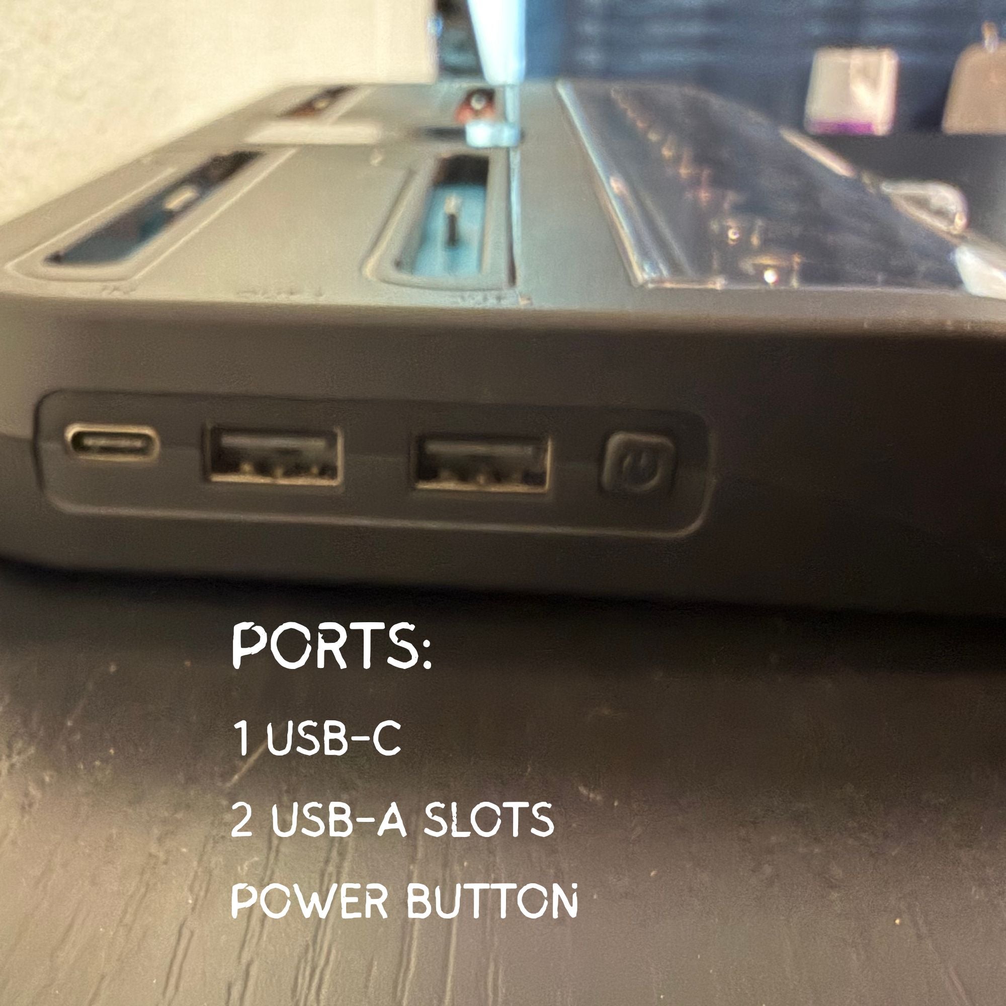 Close-up of electronic device ports with text labels on a wooden surface