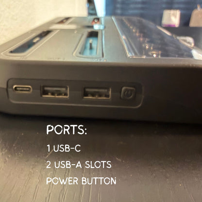 Close-up of electronic device ports with text labels on a wooden surface