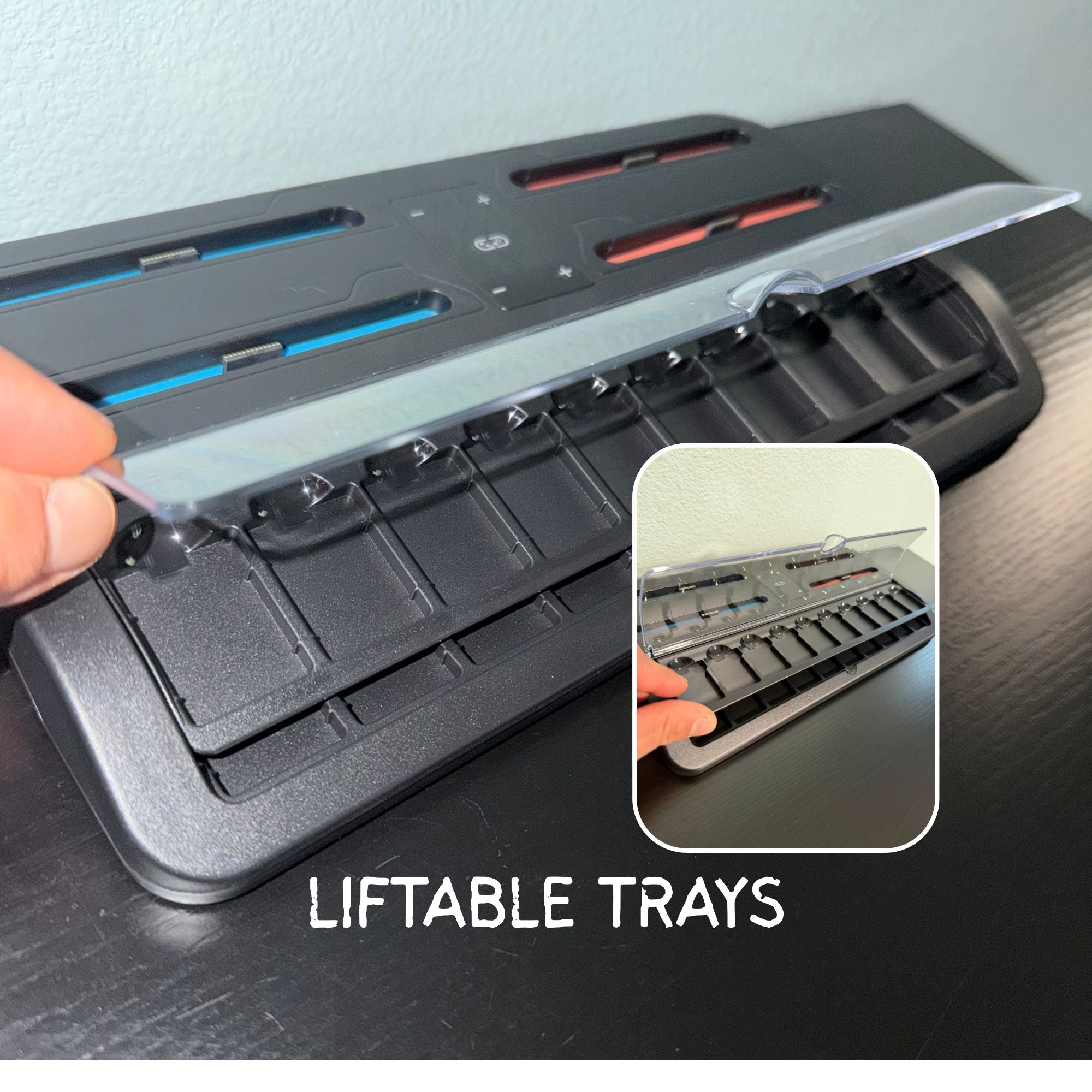 Black tool organizer with liftable trays on a dark surface