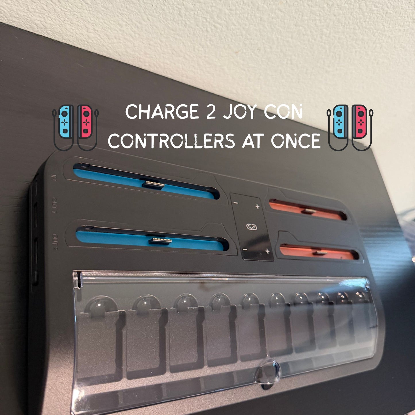 Battery charger for gaming controllers with text indicating it can charge two controllers at once.