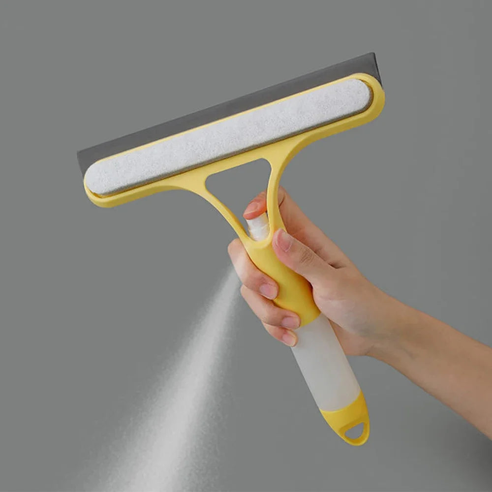 Hand holding a yellow squeegee against a gray background