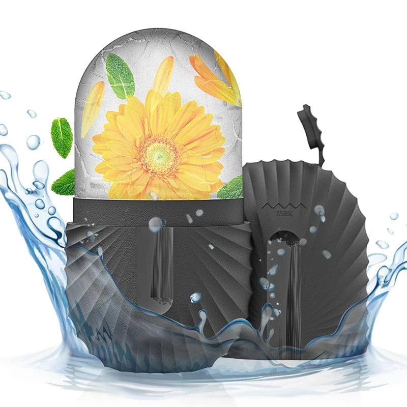 Black fan with a decorative yellow flower and green leaves on top, surrounded by water splashes.